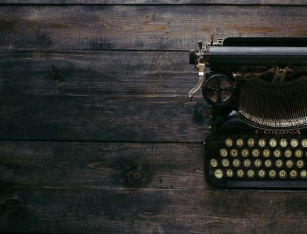 black Corona typewriter on brown wood planks