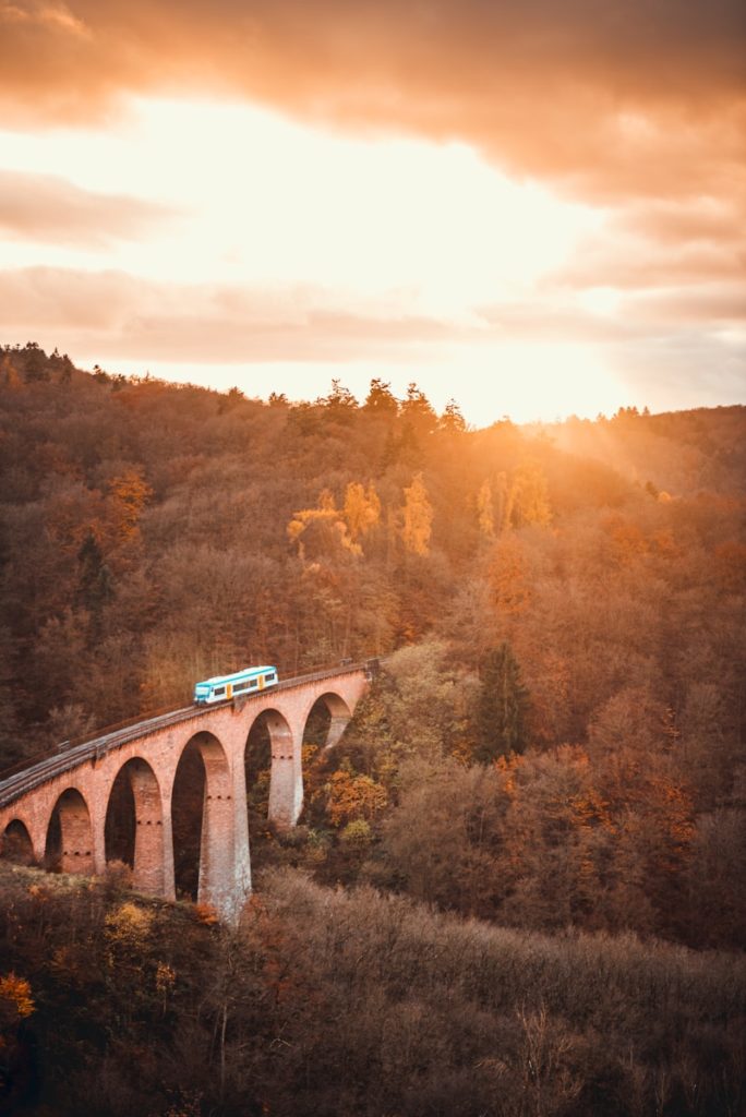 aerial view photography of train on bridge during sunset