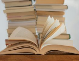 white book on brown wooden table