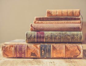 shallow focus photography of stack of books
